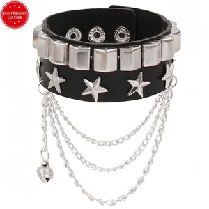 Close-up of black leather punk bracelet with silver studs, pentagrams and layered chains