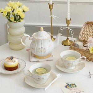 Detail of camellia tea set featuring French floral cat patterns on cream ceramic