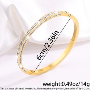 Detail showing dimensions of 6cm and 14g weight for the sparkling gold studded bangle
