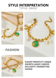 Macro view of gold beaded chain bracelet with sun, moon, and pearl charms detail