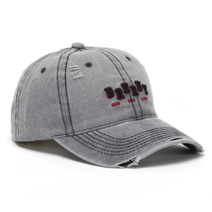 Close-up of vintage washed grey baseball cap featuring 3D letter embroidery and distressed details