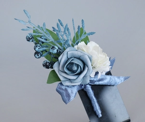 Detailed view of Morandi blue rose boutonniere with silk ribbon and berry accents
