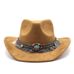 Close-up of brown suede cowboy hat featuring turquoise stone and colorful bead tassels