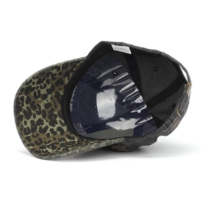 Detail view of cotton baseball cap with leopard print brim and internal quality label