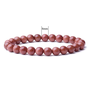 Detail view of 8mm reddish-brown goldstone beads on an elastic bracelet strand