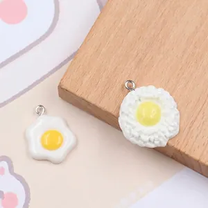 Realistic resin fried egg pendants with textured yolk and metal hooks for DIY jewelry