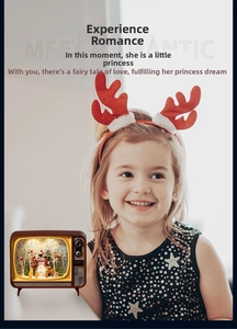 Detail of vintage Christmas TV snow globe with glowing light and miniature festive scene