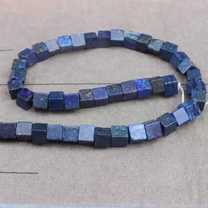 Macro view of square natural lapis lazuli cube beads showing rich blue texture and gold pyrite
