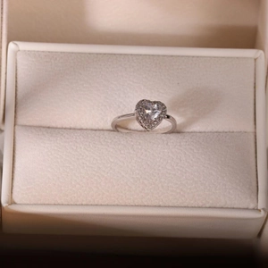 Elegant silver heart-shaped zircon ring with halo crystals in a premium gift box