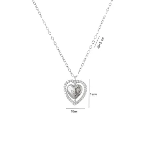 Detail of silver heart necklace with inner engraved heart and outer cubic zirconia frame