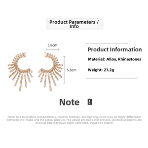 Macro view showing dimensions of large gold-tone C-shape fan earrings with white crystals