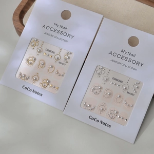 3D nail art stickers with pearls and metallic rings for elegant minimalist manicure
