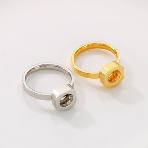Macro view of industrial nut style square rings in polished gold and silver finishes