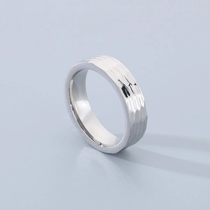 Detailed view of silver titanium steel ring featuring a unique hammered texture surface