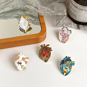 Artistic anatomical heart enamel pins with oil painting designs and floral patterns