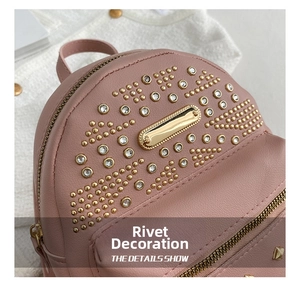 Detailed close-up of pink leather backpack featuring gold rivets and sparkling rhinestones