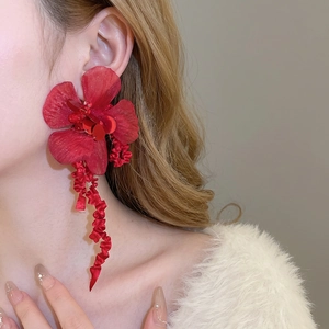 Elegant red fabric flower earrings with sparkling sequins and long flowing silk ribbons