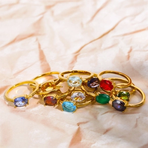 Golden stainless steel rings set with various colorful oval cubic zirconia birthstones