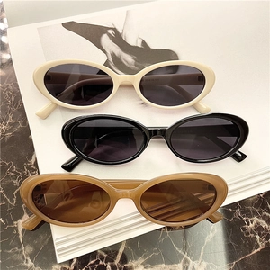 Detailed top view of retro oval sunglasses with thick frames in white, black and amber