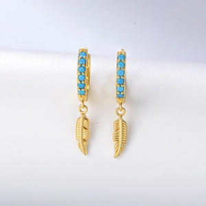 Detail of gold feather pendant earrings featuring vibrant sky blue turquoise beads