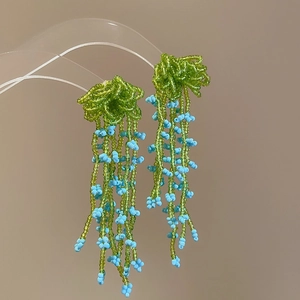 Handmade beaded tassel earrings in green and blue floral design for beach vacations