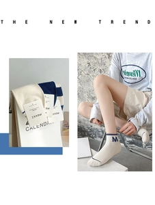 Detail of blue striped cotton ankle socks featuring tag and on-foot modeling view