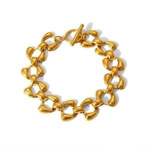 Detail of gold chain bracelet with geometric links and a secure T-bar toggle clasp