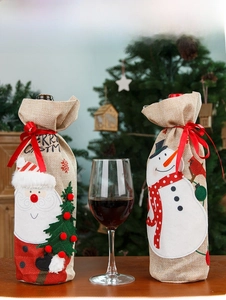 Detail of burlap Christmas wine bottle bags with Santa and Snowman embroidery in festive setting