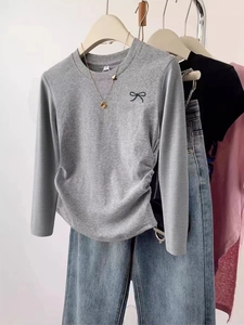 Minimalist long sleeve grey t-shirt with small bow detail and side ruched design
