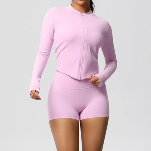 Detail of high-stretch lilac yoga set featuring slim-fit zipper jacket and high-waist shorts