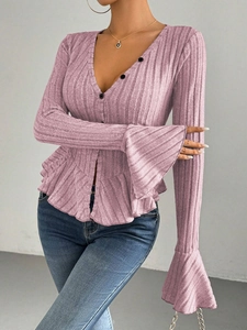 Detail of V-neck mauve knit top featuring ruffled hem and elegant flared bell sleeves