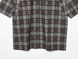 Close-up of brown-gray plaid pattern and woven fabric texture on a casual trench jacket