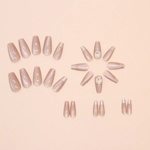 Detailed view of cat-eye press-on nails with silver French tips and large rhinestones
