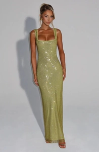 Detailed view of the sparkling sequin mesh fabric on a backless green party dress