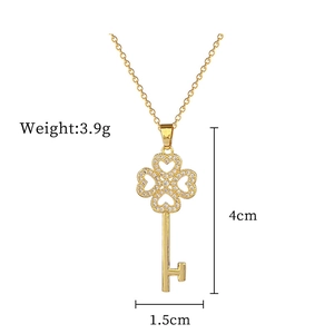 Detail of gold clover key pendant with crystals showing size 4cm length and 3.9g weight
