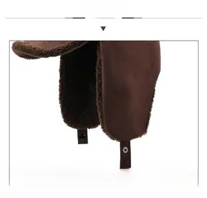 Close-up of brown suede winter trapper hat with thick faux sheepskin fleece lining