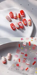 Detail of 3D embossed New Year nail stickers featuring cute rabbits and red fireworks