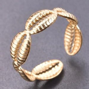 Macro detail of adjustable gold titanium ring with shell-inspired spiral textures