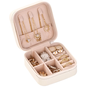 Portable cream white travel jewelry organizer with pink lining and multi-compartment interior