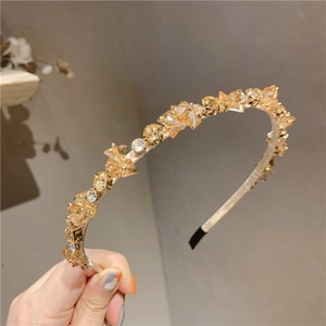 Detailed view of hand-set amber and clear faceted crystals on a slim elegant headband