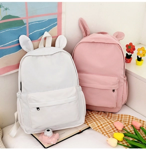Detail of white and pink rabbit ear backpacks featuring a cute Japanese-style design
