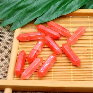 Natural red crystal hexagonal column pendants displayed on a bamboo tray for DIY jewelry