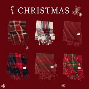 Flat lay of festive plaid scarves with tassels in various colors and Christmas decor