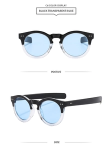Close-up of black transparent round sunglasses with blue lenses and silver rivets detail