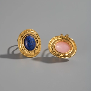Detail of vintage gold textured rings with lapis lazuli and pink opal gemstones