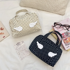 Polka dot canvas tote bag with 3D wing detail for travel and cosmetics