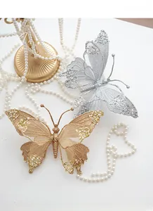 Detail showing gold and silver mesh butterfly Christmas tree ornaments with sequins and pearls