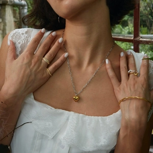 Elegance 18k gold heart pendant necklace with silver chain on model, trendy chic style
