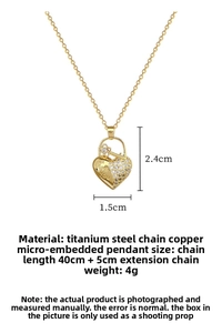Detail of gold heart pendant with Love You engraving and crystal flower key charm