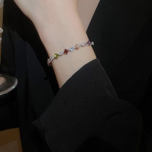 Detail of a silver bracelet with colorful zircon stones in square and marquise cuts